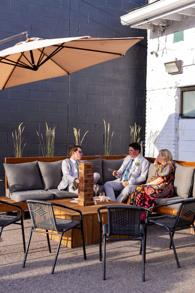 Wedding guests sitting outside at SKYLIGHT in Denver