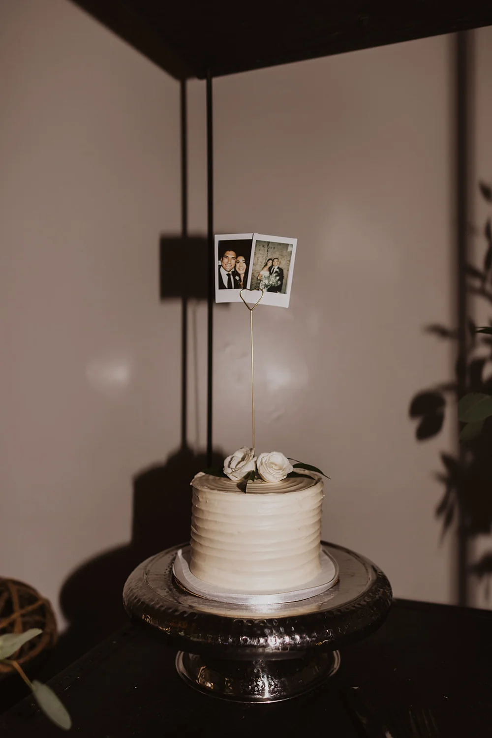 Polaroid photos on top of a wedding cake