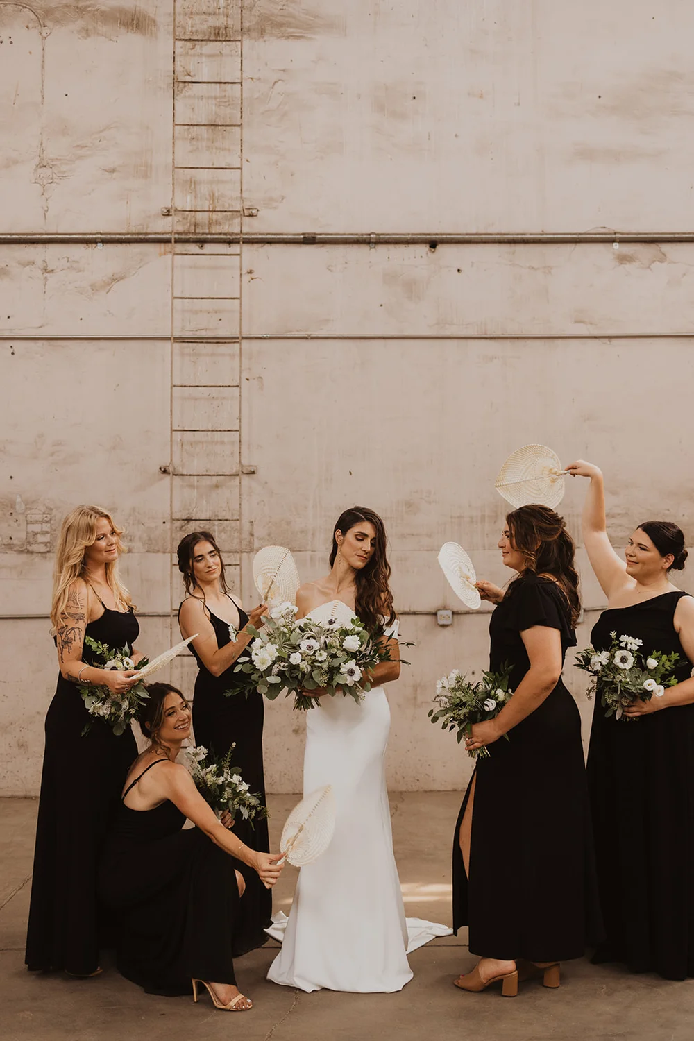 Bride and bridesmaids taking photos outside of Blanc in Denver