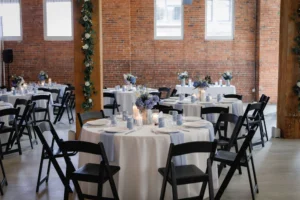 Reception at THE 101 in Seattle with beautiful white and blue linens, and greenery on the pillars