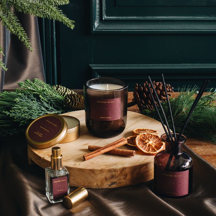 Holiday candles and diffuser oils creating a warm, inviting scent for guests