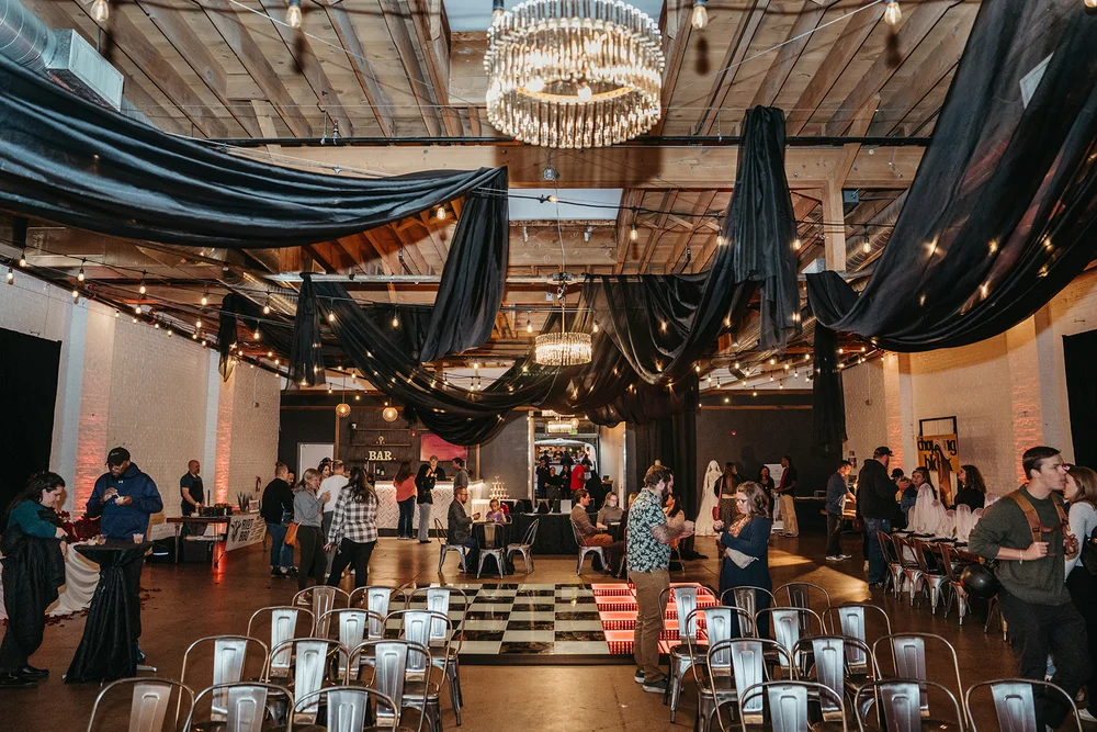 Wide view of SKYLIGHT Denver venue transformed for a moody ’Til Death wedding open house by 828 Planning