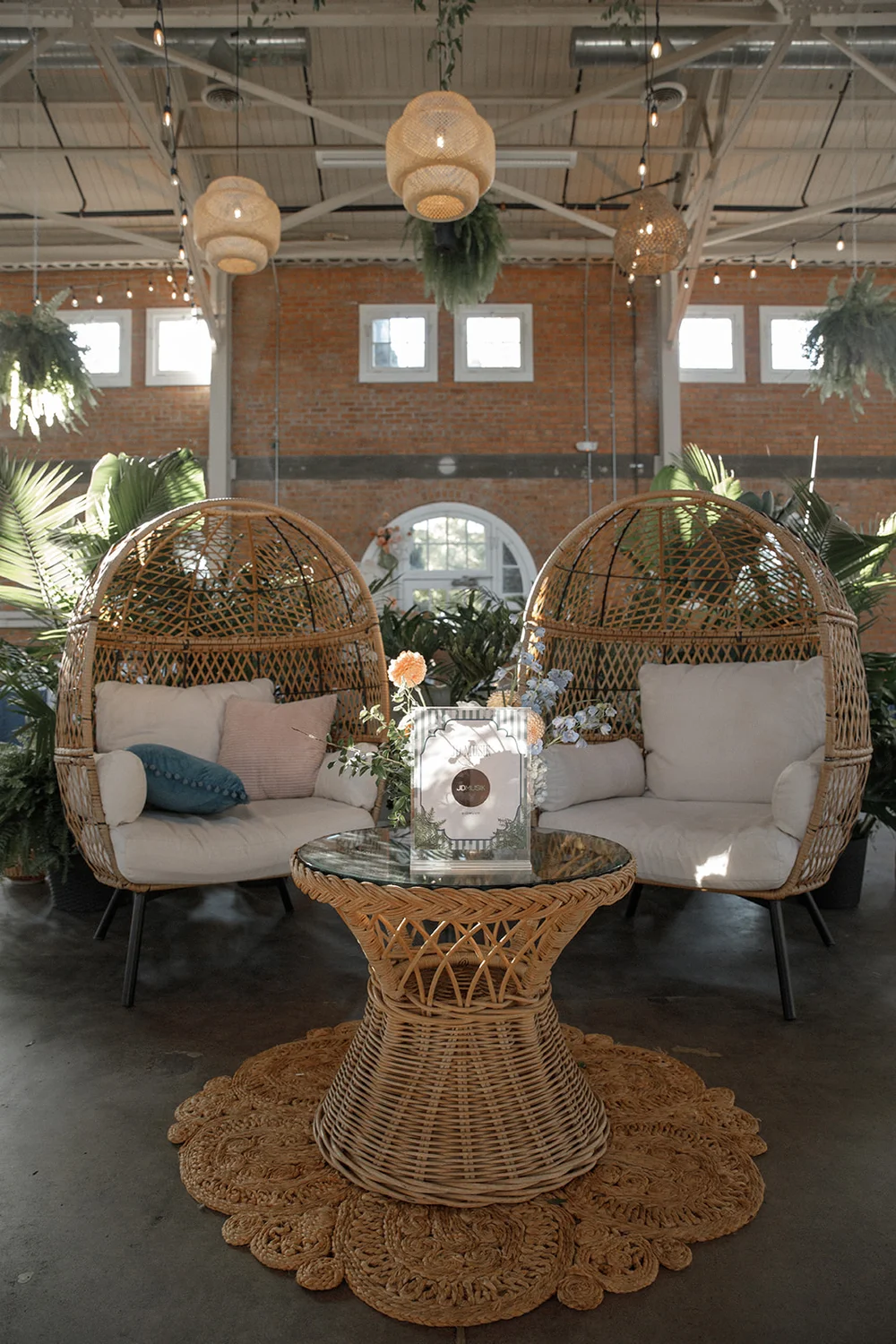 Rattan egg chairs and a table set up for a lounge vignette done by 828 Planning 