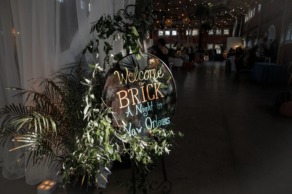 Welcome to BRICK sign written on a gold mirror at BRICK San Diego open house planned by 828 Planning