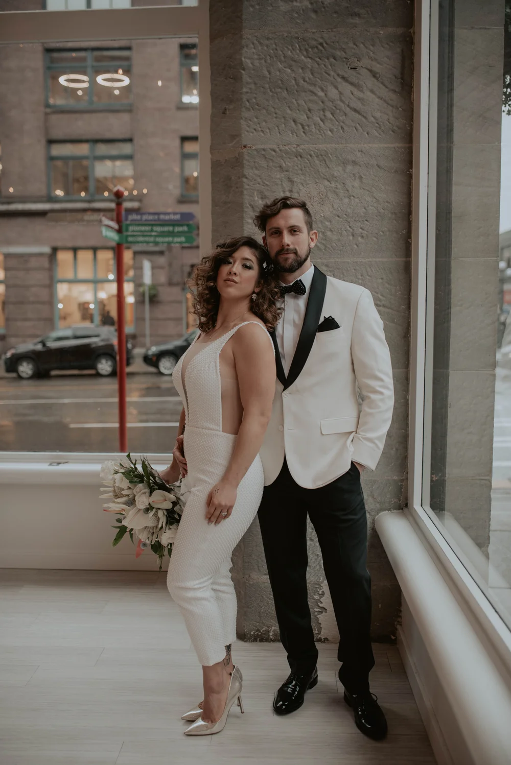 Bride and groom posing at The 101 venue in Seattle