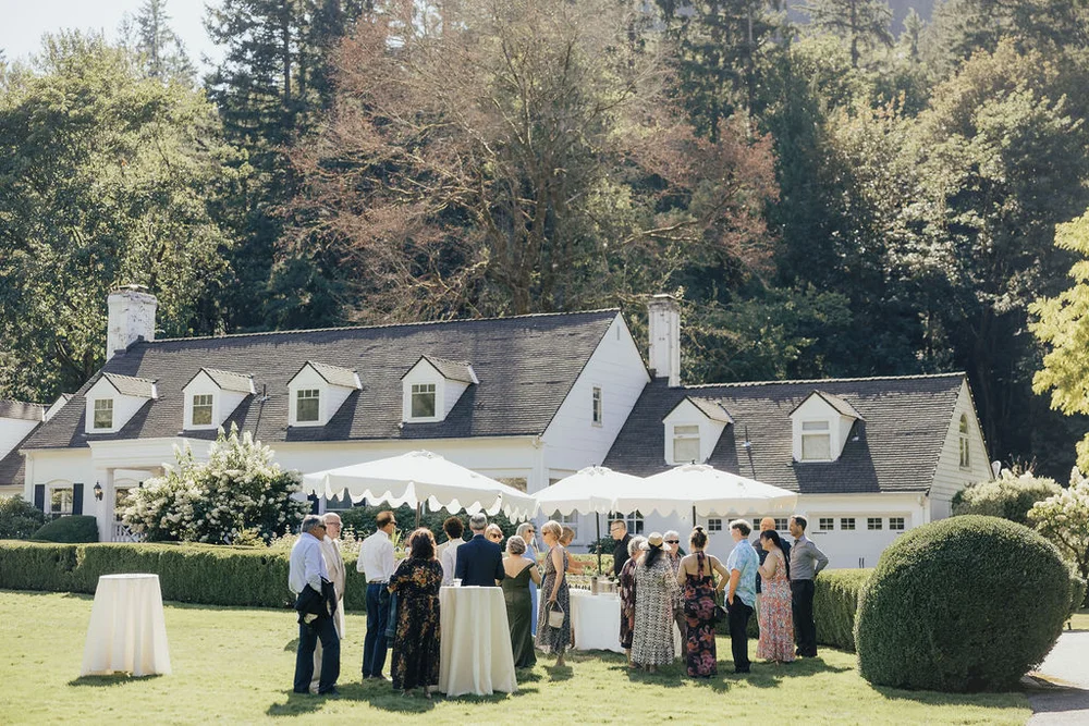 Guests standing outside for cocktail hour on the lawn